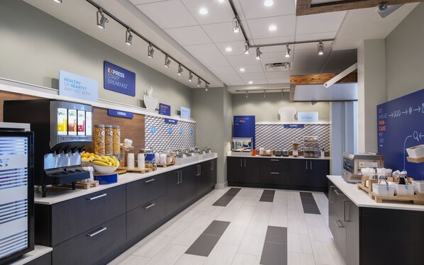 A modern breakfast area with a self-serve station, cereal and hot food options, and a bakery section. - Holiday Inn Express & Suites Kelowna - East by IHG (Kelowna)