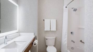 A bathroom with a sink, toilet, and bathtub.