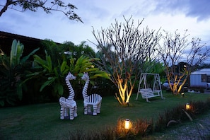A garden with zebra statues, a swing set, and a lamp post. - Be Cool Boutique at Phu Ruea (Phu Ruea)
