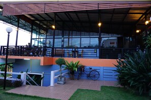 Un espacio al aire libre con mesas, sillas, una bicicleta y plantas en macetas.