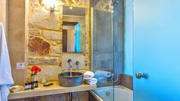 Separate bathtub and shower, designer toiletries, towels, toilet paper