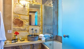 Separate bathtub and shower, designer toiletries, towels, toilet paper