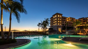 A hotel with a swimming pool surrounded by palm trees and lounge chairs. - Westin Carlsbad Resort & Spa (Carlsbad)