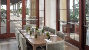 A dining area with a long table, chairs, and a chandelier. - Westin Carlsbad Resort & Spa (Carlsbad)