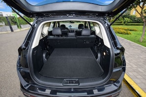 A car with its trunk open, revealing a spacious cargo area.