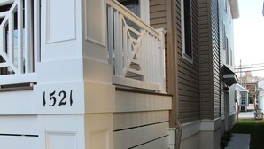 A residential house with a white front porch, a mailbox, and a number '1521' on the wall. - Upscale New 3BR 2nd Floor Condo • 2 Blocks to Beach • Walk to Boardwalk & Town (Ocean City)