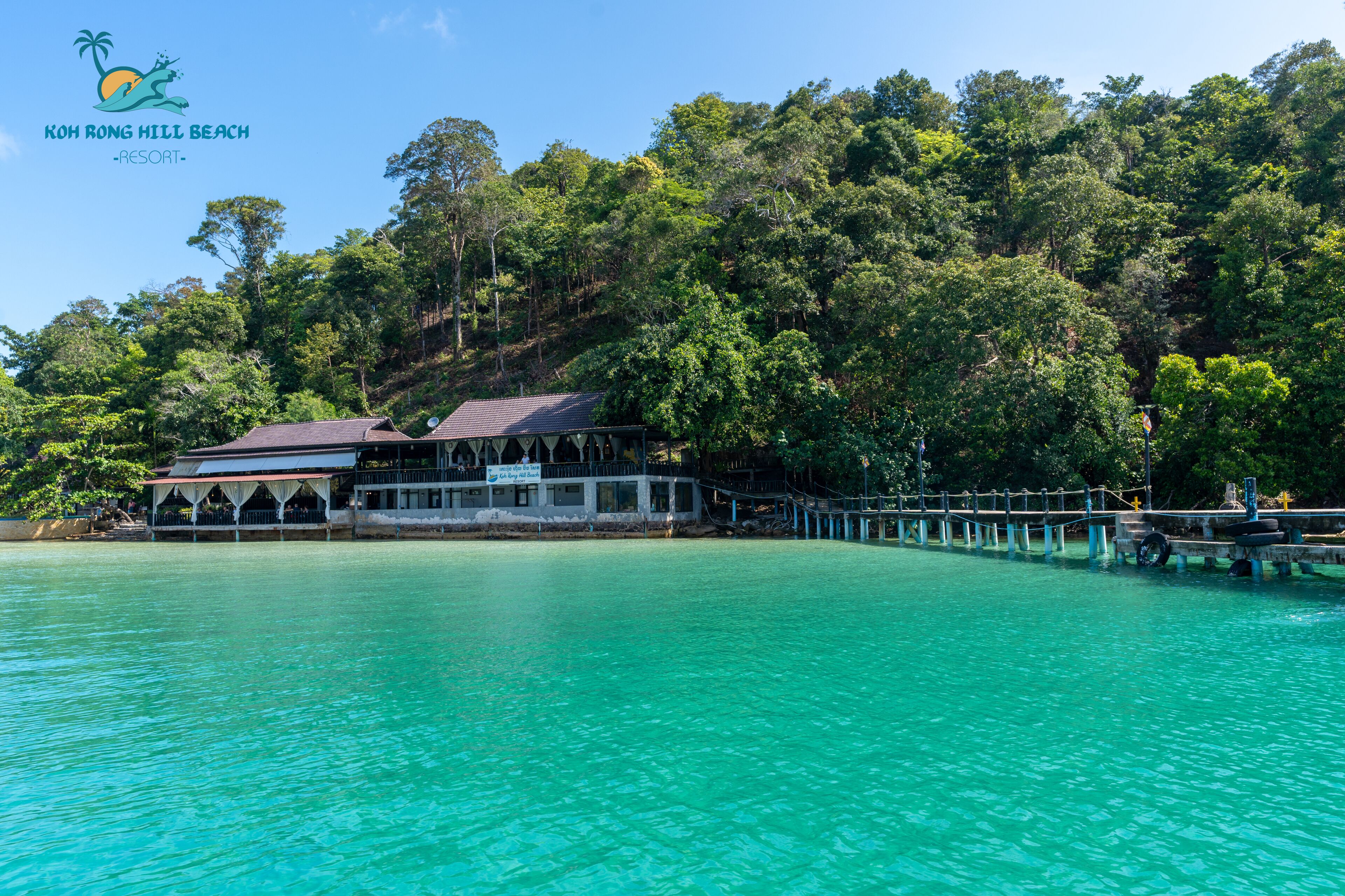 Koh Rong Hill Beach Resort with a view of the turquoise water and lush greenery.