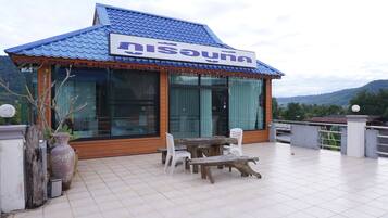 Traditional Thai restaurant with a view of the surrounding landscape.
