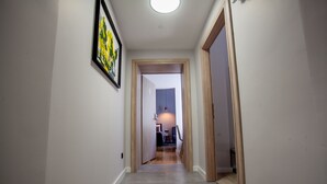 A hallway with a door labeled '6' leading to a room with a bed and a desk. - Zagreb City Vibe Apartments & Rooms (Zagreb)