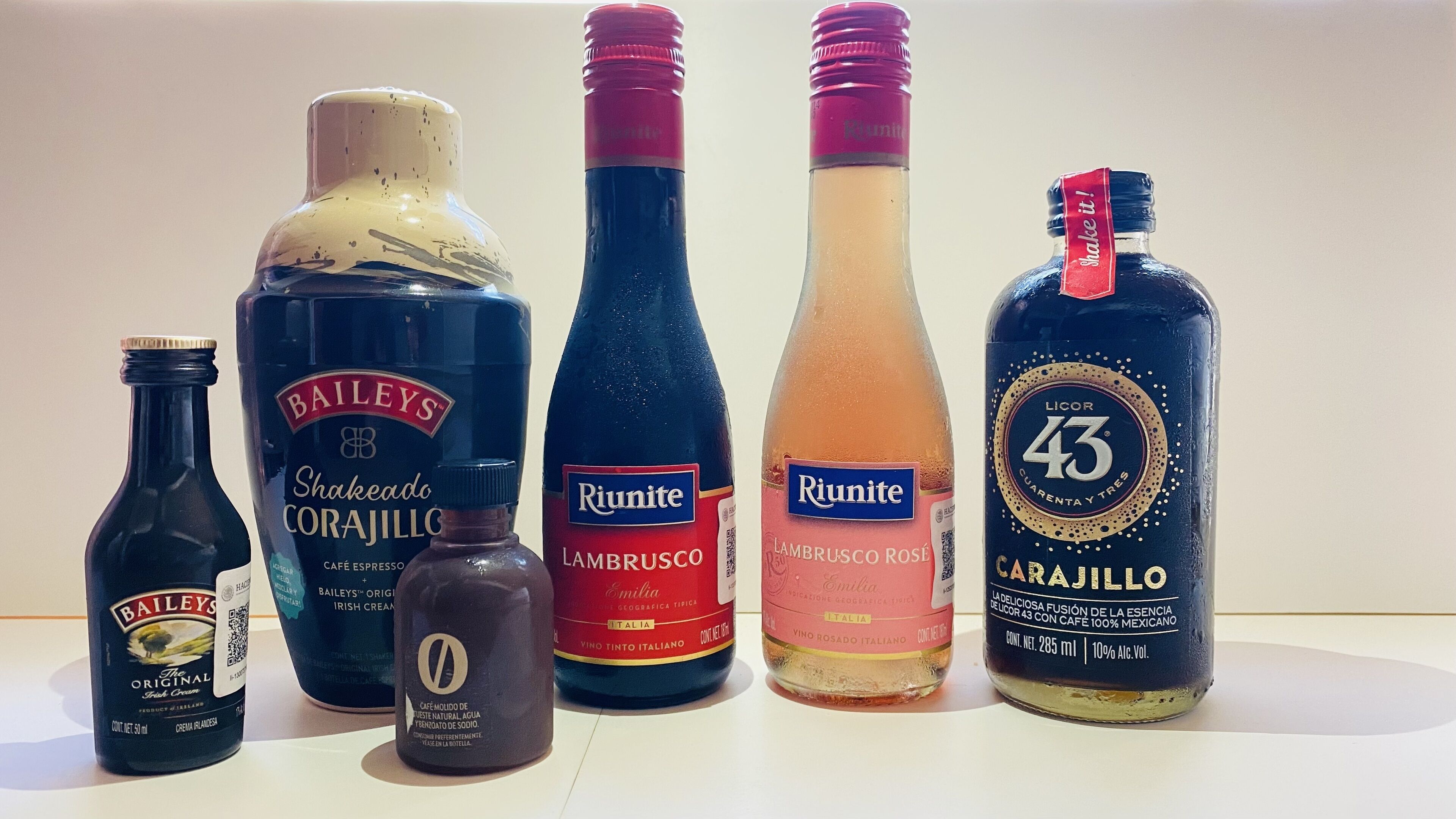 Six bottles of different beverages.