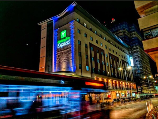 A hotel with a prominent 'Hyatt Express' sign, multiple floors, and a modern architectural design.