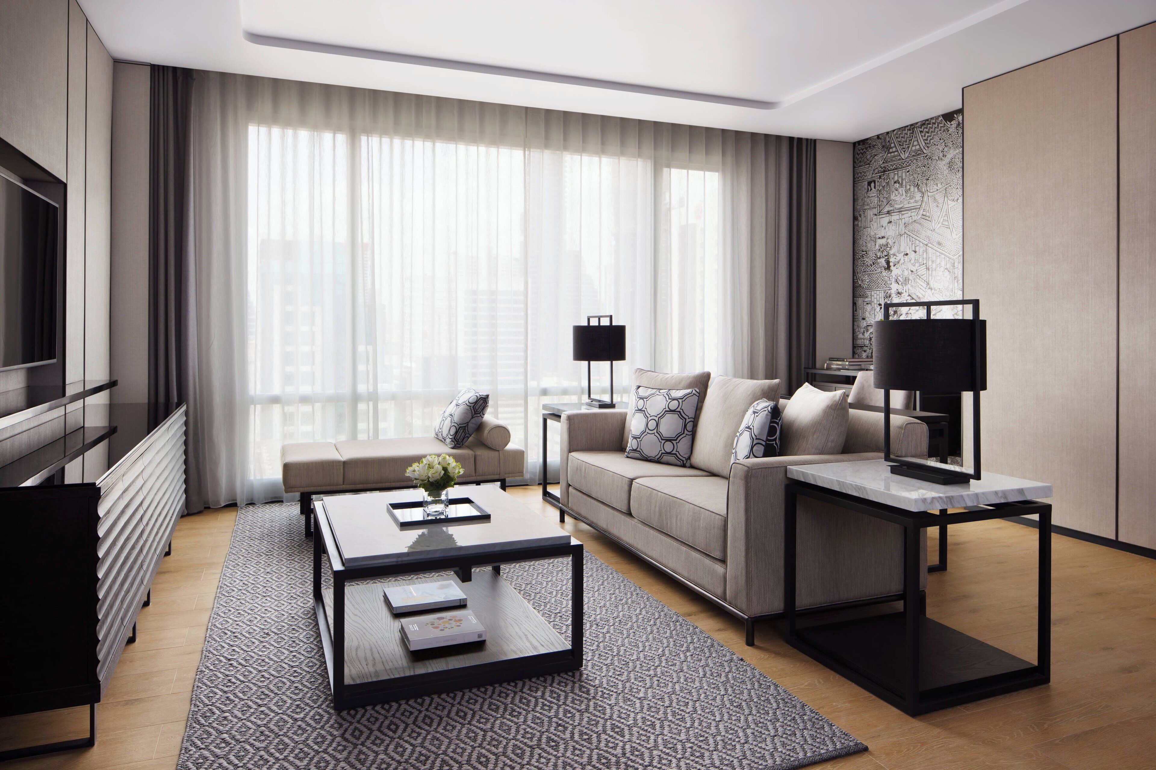A modern living room with a sofa, coffee table, and a TV.