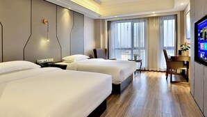 A hotel room with two beds, a desk, a chair, a TV, and a large window with curtains. - Mercure Hangzhou Linping Hotel (Hangzhou)