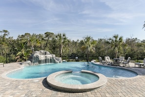 The pool also features a grotto sitting are