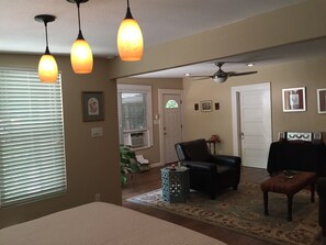 Relax in this stylish living room with a ceiling fan, leather armchair, and area rug.
