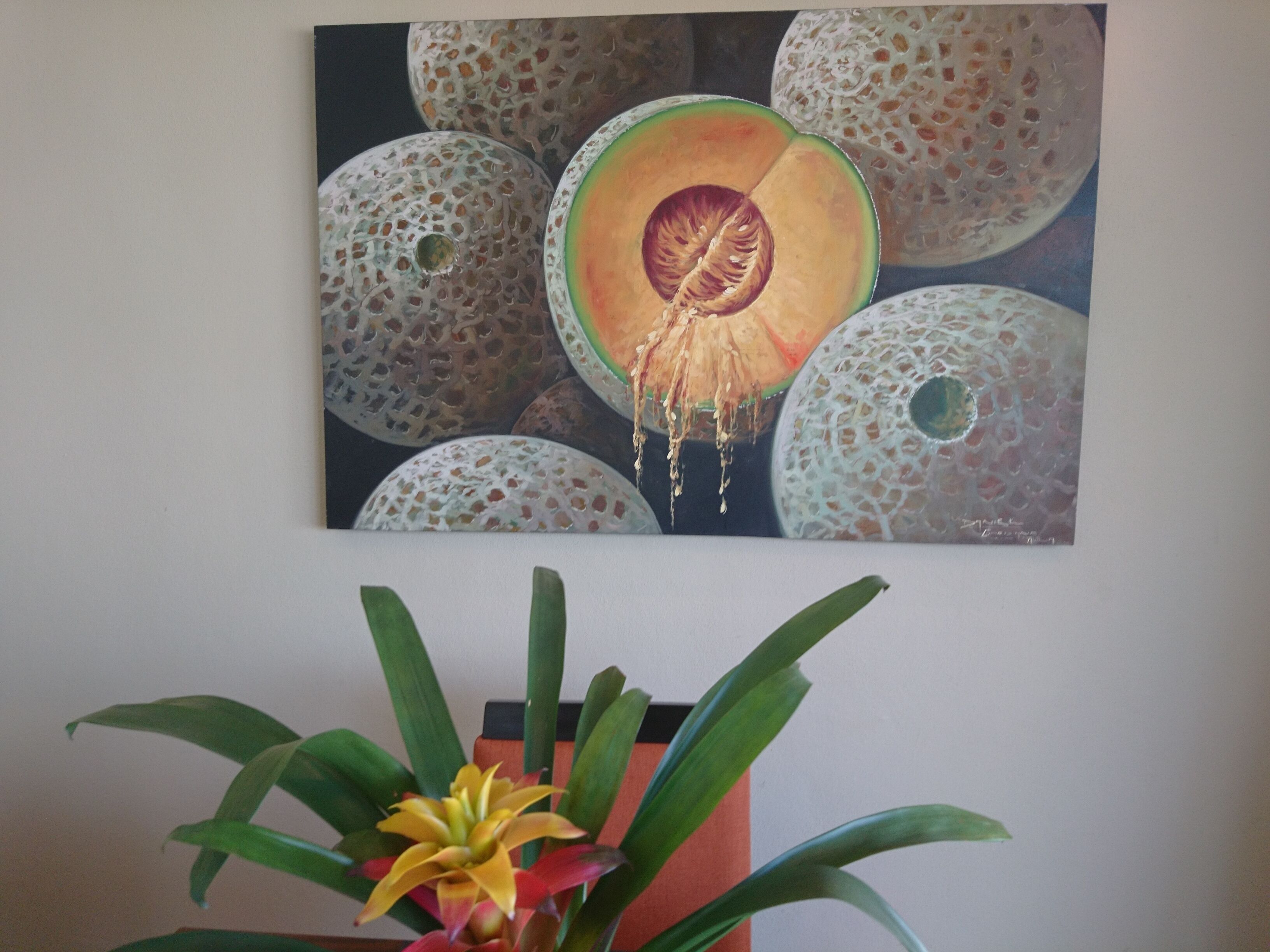 A painting of avocados on a wall.