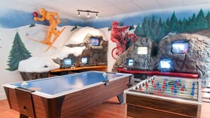 A recreational room with a foosball table, a pool table, and a ski-themed mural. - HILTON GVC NEW YEAR'S 2026-27 - 6 Nights (Mont-Tremblant)