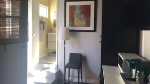 A modern kitchen with a coffee maker, a framed abstract painting, and a chair. - STUDIO AWESOMENESS FOR YOU LMU SILICON BCH VENICE (Los Angeles)