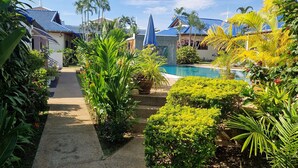 A tropical resort with a swimming pool, lush greenery, and traditional architecture. - LARGE VILLA SWIMMING POOLS TROPICAL GARDEN SEA GOLF RELAXATION 6 /12 ADULTS (Phuket)