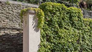 A stone staircase leading to a building with a balcony.