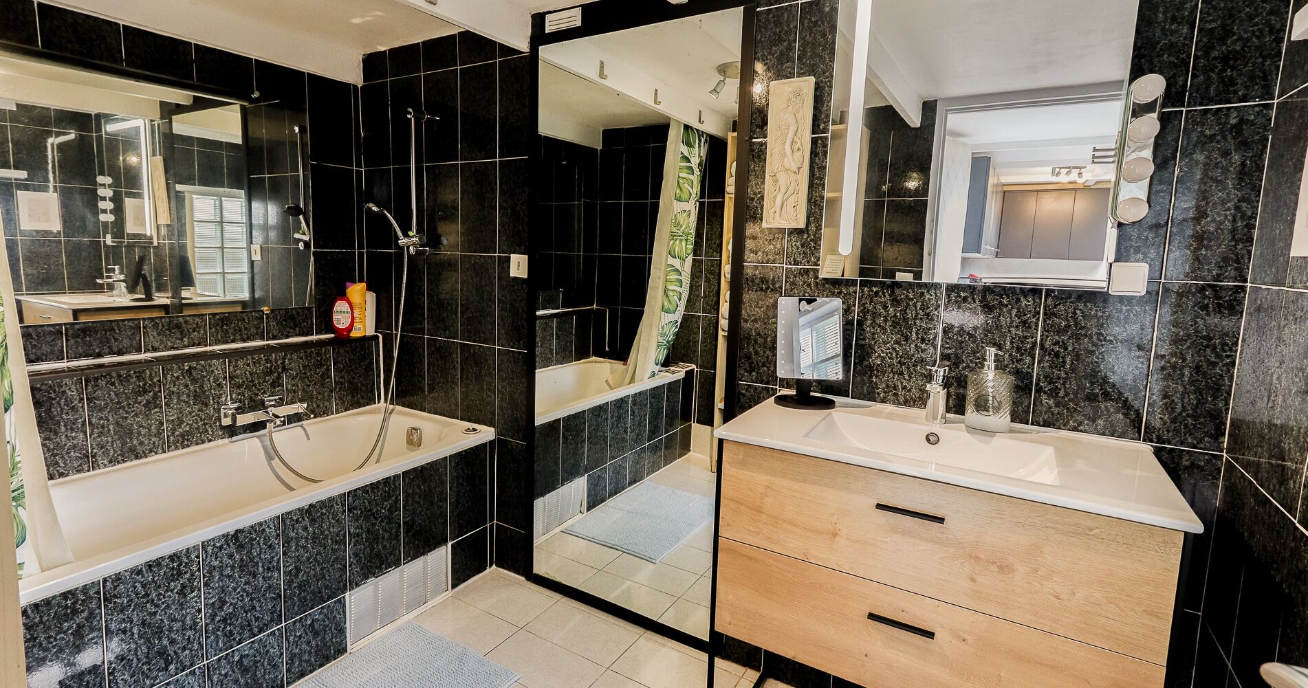 A modern bathroom with a bathtub, a sink, and a vanity.