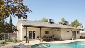 A house with a pool, patio furniture, and a covered outdoor seating area. - The Pineapple House -Best Reviews- Refreshing Swimming Pool! (Redding)