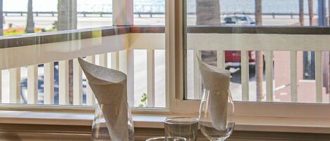 A table with a bowl, a wine glass, and a water glass.