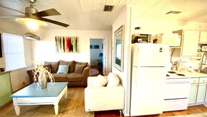 A compact living space with a kitchenette, a ceiling fan, a dining table, and a sofa. - 2 Minute walk to the secluded beaches of Fort Morgan! Pet friendly! Quiet Space! (Gulf Shores)