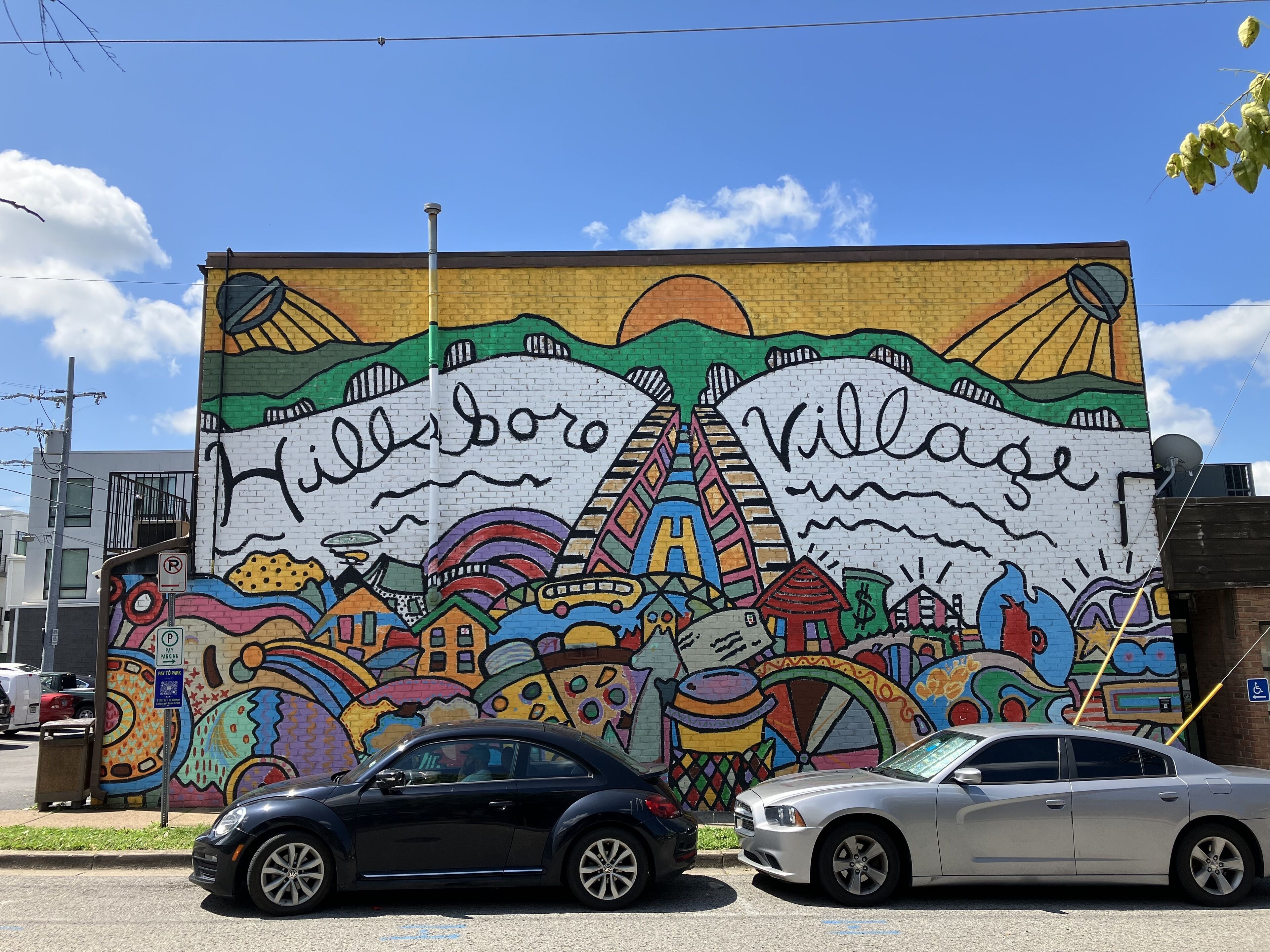 A mural with the words "Villaborg" and "Village" on a brick wall.