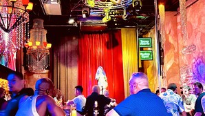 A bar area with a stage, red curtains, and hanging lights. - Los Muertos Beachfront Art Condo with Pano View:  Best Romantic Zone Location (Puerto Vallarta)