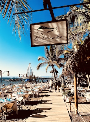 The beach chairs and boardwalk in front of the El Dorado Restaurant