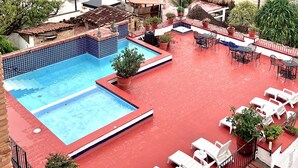 A rooftop pool area with a view of a beach and ocean. - Los Muertos Beachfront Art Condo with Pano View:  Best Romantic Zone Location (Puerto Vallarta)