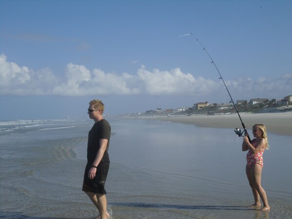 A beach scene with a man and a woman fishing. - On No Drive Beach! Luxury 3 BdRm, 3 Baths, Mst wSpa; Ocean & Riverview Balconies (Daytona Beach)