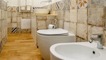 A bathroom with a sink, toilet, and shower.