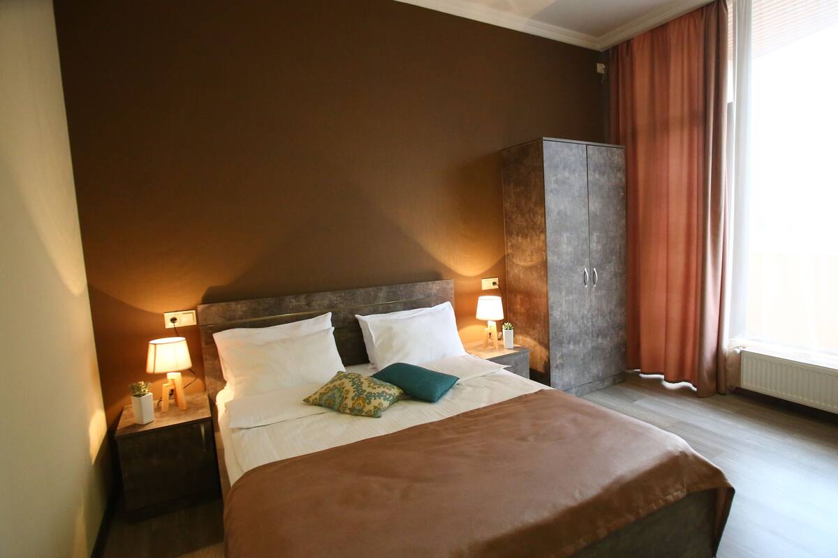 Premium bedding, desk, laptop workspace, soundproofing
