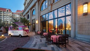 A van parked outside a building with large windows and a brick facade. - Crowne Plaza Qingdao Oriental Movie Metropolis by IHG (Qingdao)