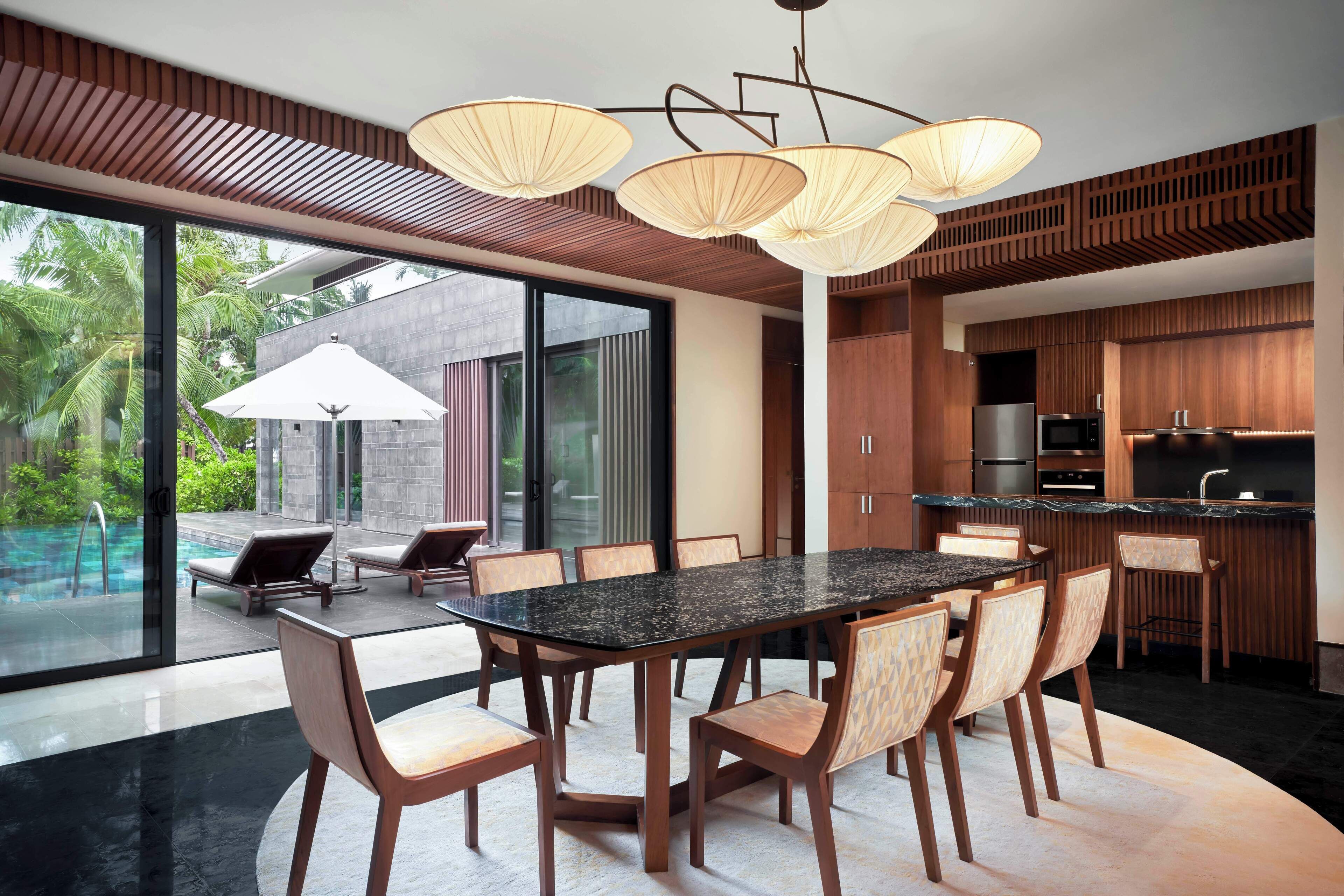 A modern kitchen with wooden cabinets, a granite countertop, and a built-in oven.