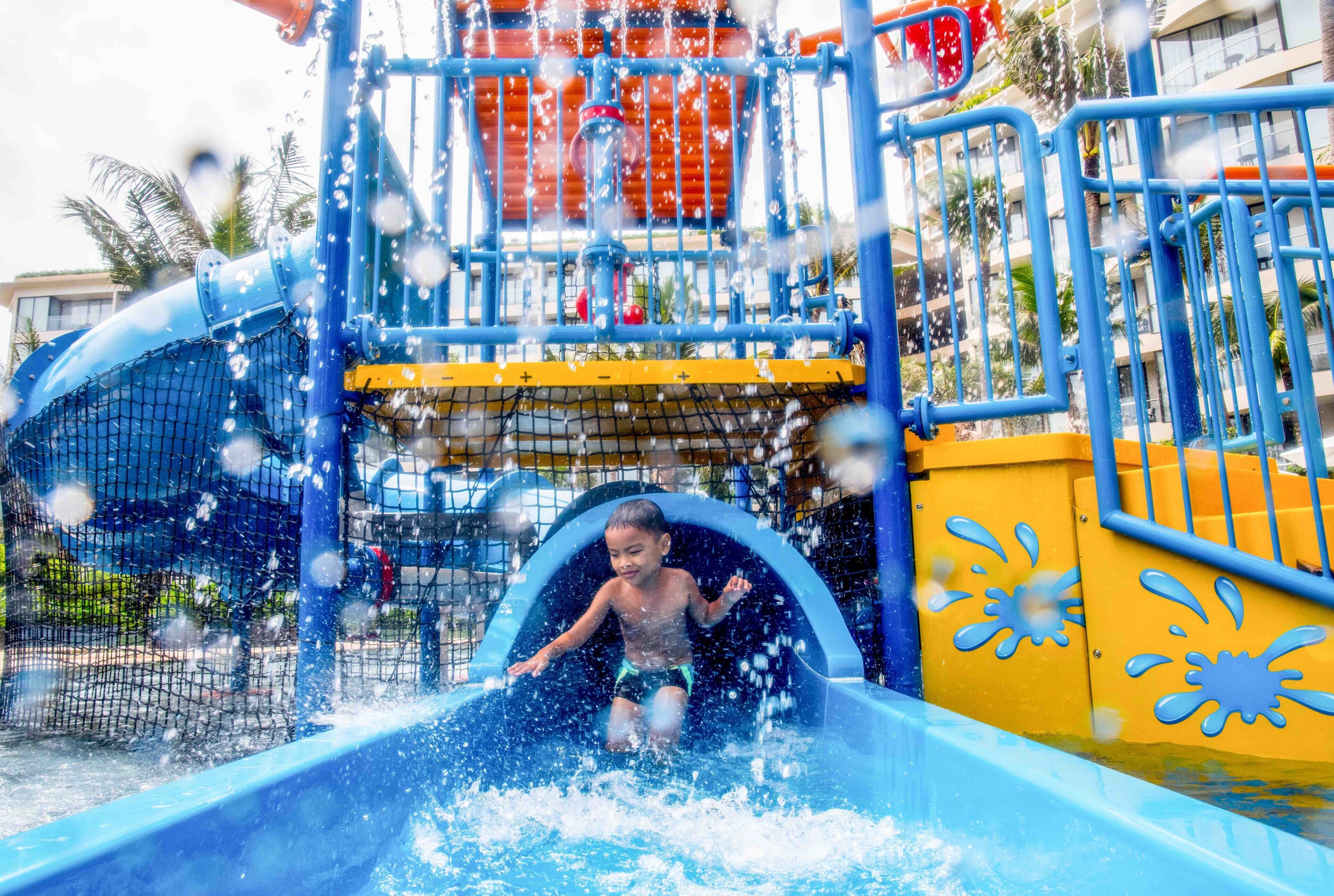 A water play area with a slide and splash zone.