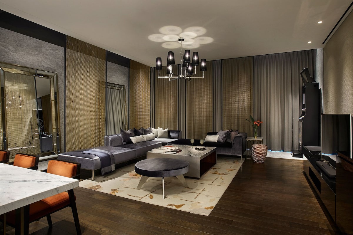 A modern living room with a sectional sofa, a round coffee table, and a TV.