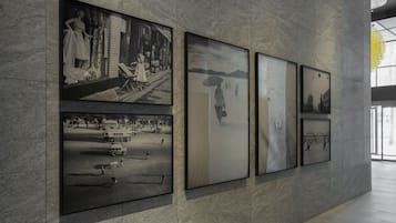 Pared con cuatro fotografías en blanco y negro enmarcadas que muestran diferentes escenas.