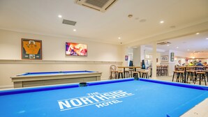 A pool table with "The Northside Hotel" branding, a billiards table, and a bar area with stools and tables. - Northside Hotel Albury (Lavington)