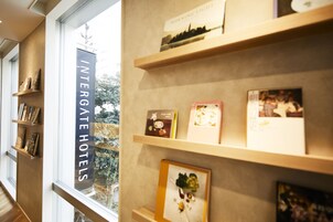 A hotel interior with shelves displaying framed pictures and a sign reading "INTERGATE HOTELS".