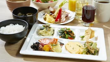 Una comida con diferentes platos y bebidas sobre una mesa.