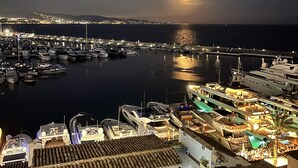 A marina at night with boats docked, a large yacht, and a cityscape in the background. - ´Beach & Golf' Large Family Villa, Huge Garden, Private Pool, 350m to the Beach. (Marbella)