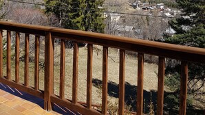 A balcony with a view of a mountainous landscape, including snow-capped peaks and a village below. - Val D'Allos mountain chalet for 8 people (Villars-Colmars)