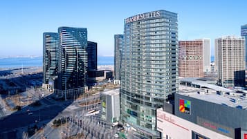 Experience the sleek, modern architecture of Frasers Suites, set amidst a vibrant urban landscape.