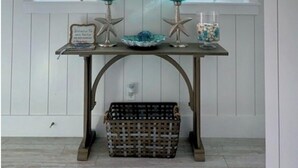 A room with a stone wall, a hanging light fixture, two windows, a table with starfish decorations, and a wicker basket. - Gated Waters Edge, deeded beach, chair set up, private pool, 5 bed\5+ sleeps 16 (Rosemary Beach)