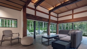 A modern interior with a sofa, chair, ottoman, and coffee table. - ryugon (Minamiuonuma)