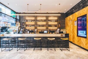 A modern bar area with a wooden wall and a digital screen displaying information. - Atour Light Hotel Bund Shanghai (Shanghai)