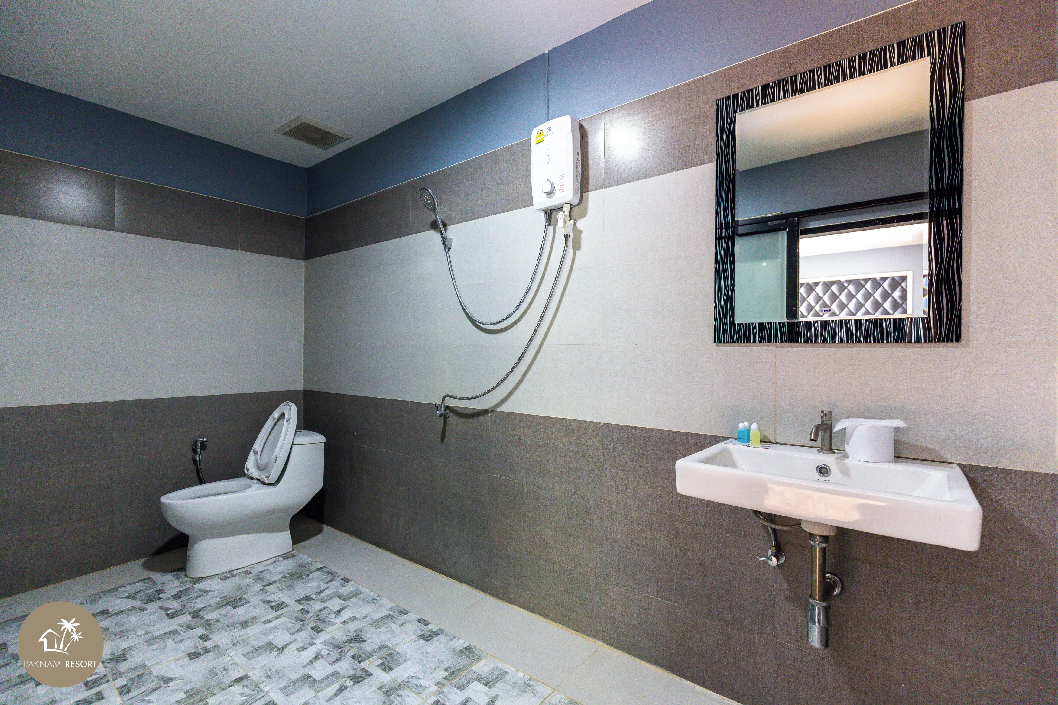 A bathroom with a toilet, a sink, and a shower.